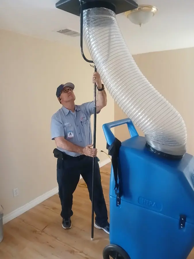 Furnace Tune-Up technician using HEPA equipment in Trumann